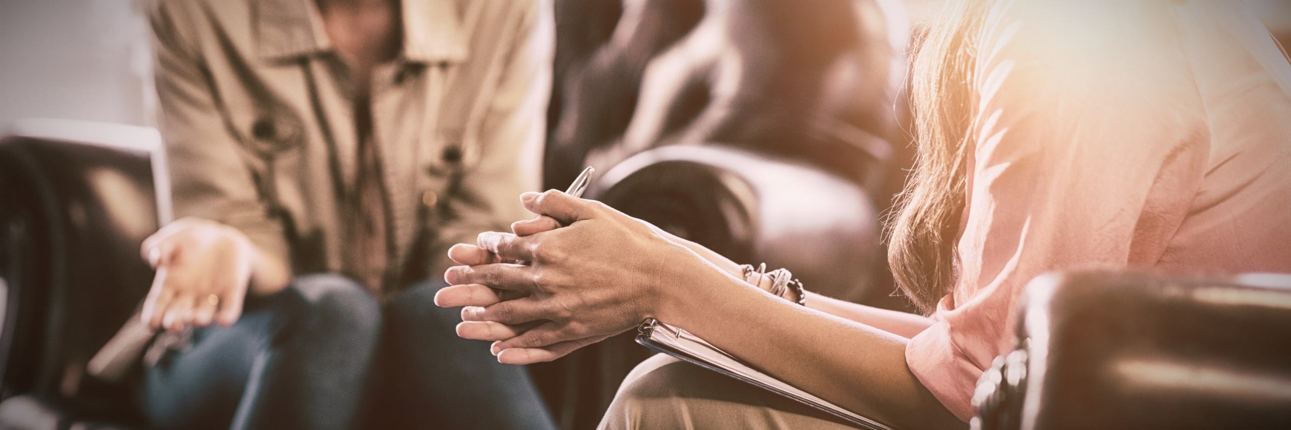 A therapist listens to a patient